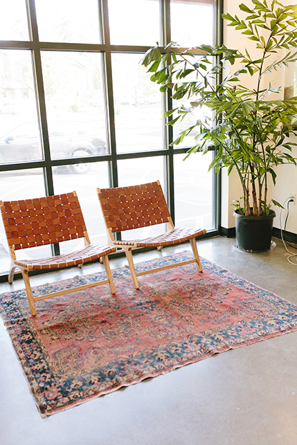 The front seating area featuring ornate area rugs and woven chairs